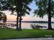 Scenic lake view with a dock under a serene sunset, framed by mature trees at 120 Ole Point Ln, Salisbury, NC 28146