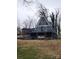 A-frame house with large windows, outdoor seating, grill, and stone foundation at 120 Ole Point Ln, Salisbury, NC 28146
