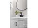Stylish bathroom featuring a sleek vanity with a modern faucet and decorative round mirror at 121 Dabbling Duck Cir, Mooresville, NC 28117