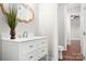 Elegant powder room featuring a white vanity with marble countertop and decorative gold mirror at 121 Dabbling Duck Cir, Mooresville, NC 28117