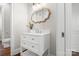 Stylish powder room featuring a white vanity, modern mirror, and hardwood floors at 121 Dabbling Duck Cir, Mooresville, NC 28117
