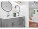 Bathroom featuring a double vanity with modern fixtures and an adjoining bedroom at 121 Dabbling Duck Cir, Mooresville, NC 28117