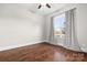 Bright bedroom with hardwood floors, a ceiling fan, and a large window at 121 Dabbling Duck Cir, Mooresville, NC 28117