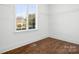 Well-lit bedroom offers hardwood floors and a bright window with neighborhood views at 121 Dabbling Duck Cir, Mooresville, NC 28117
