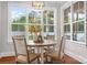 Bright dining area features a round table with wood chairs and large windows at 121 Dabbling Duck Cir, Mooresville, NC 28117