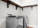 Efficient laundry room with modern stainless steel washer and dryer, plus convenient shelving at 121 Dabbling Duck Cir, Mooresville, NC 28117