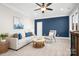 Cozy living room with comfortable seating, accent wall, and natural light perfect for relaxing at 121 Dabbling Duck Cir, Mooresville, NC 28117