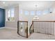 Open loft area with decorative railing, chandelier and many windows for natural light at 121 Dabbling Duck Cir, Mooresville, NC 28117
