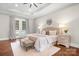 Bright main bedroom featuring tray ceilings, a bench, and ensuite bathroom access at 121 Dabbling Duck Cir, Mooresville, NC 28117