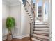 Elegant staircase with wood treads, white risers, and iron balusters creates a grand entrance at 121 Dabbling Duck Cir, Mooresville, NC 28117