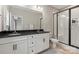 Bathroom featuring dual sinks, granite countertops, and a glass-enclosed shower with white subway tile at 12312 Landry Renee Pl # 35, Charlotte, NC 28277