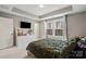 Bedroom with a trey ceiling, white trim, carpeted floors and a double window for plenty of natural light at 12312 Landry Renee Pl # 35, Charlotte, NC 28277