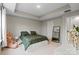 Well-lit bedroom with trey ceiling, carpet floors, and large windows; furnished with a queen bed and a dresser at 12312 Landry Renee Pl # 35, Charlotte, NC 28277