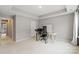 Neutral bedroom featuring a tray ceiling, gray walls, and space for an office setup at 12312 Landry Renee Pl # 35, Charlotte, NC 28277