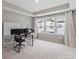 Spacious bonus room with carpet flooring, bright windows, a tray ceiling, and ready for home office setup at 12312 Landry Renee Pl # 35, Charlotte, NC 28277