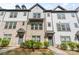 Townhome exteriors boasting brick and siding details, enhanced by manicured greenery at 12312 Landry Renee Pl # 35, Charlotte, NC 28277