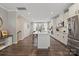 Modern white kitchen with stainless steel appliances, a large island, and a window for plenty of natural light at 12312 Landry Renee Pl # 35, Charlotte, NC 28277
