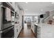 Modern kitchen featuring stainless steel appliances, quartz countertops, and an open floor plan at 12312 Landry Renee Pl # 35, Charlotte, NC 28277
