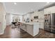Bright kitchen with white cabinets, stainless steel appliances, and island overlooking an adjacent dining area at 12312 Landry Renee Pl # 35, Charlotte, NC 28277