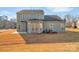 Two-story home's backyard featuring a patio, green siding, and various windows and doors providing natural light at 12724 Hunting Birds Ln, Charlotte, NC 28278