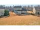A sprawling backyard with dying grass, a two-story home, and a partial fence line showing the property's boundaries at 12724 Hunting Birds Ln, Charlotte, NC 28278