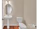 Powder room featuring a pedestal sink and modern fixtures at 12724 Hunting Birds Ln, Charlotte, NC 28278