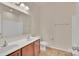 Bathroom featuring double sinks, tile floors, and a large mirror at 12724 Hunting Birds Ln, Charlotte, NC 28278