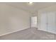 Bright bedroom featuring neutral walls, carpeted floors, and a closet providing ample storage space at 12724 Hunting Birds Ln, Charlotte, NC 28278