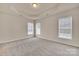 Spacious bedroom with tray ceilings and large windows providing natural light at 12724 Hunting Birds Ln, Charlotte, NC 28278
