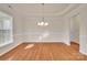 A pristine dining room with hardwood floors and a modern chandelier at 12724 Hunting Birds Ln, Charlotte, NC 28278