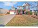 Charming two-story home with a two-car garage and a well-maintained lawn at 12724 Hunting Birds Ln, Charlotte, NC 28278