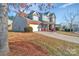 Two-story home with brick, stone, gray siding, and a 2-car garage at 12724 Hunting Birds Ln, Charlotte, NC 28278