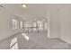 Bright hallway offering natural light through large windows and carpeted floors connecting different sections of the house at 12724 Hunting Birds Ln, Charlotte, NC 28278