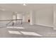 Spacious hallway with carpeted floors, neutral walls, and natural light, connecting various rooms in the house at 12724 Hunting Birds Ln, Charlotte, NC 28278