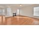 Open living room with fireplace, hardwood floors, and great natural light at 12724 Hunting Birds Ln, Charlotte, NC 28278