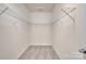 Walk-in closet with neutral carpet and shelving ready for organizing clothes and shoes at 12724 Hunting Birds Ln, Charlotte, NC 28278