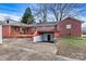 View of the backyard, featuring a brick home with a covered back porch and basement entrance at 1407 17Th Ne Ave, Hickory, NC 28601