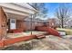 Brick home featuring a covered back porch, open patio, and an entrance to the basement at 1407 17Th Ne Ave, Hickory, NC 28601
