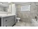 Modern bathroom featuring tile floor and walls, a gray vanity, and shower-tub combination at 1407 17Th Ne Ave, Hickory, NC 28601