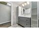 Bathroom featuring a gray vanity with storage, tile accents, and an enclosed shower at 1407 17Th Ne Ave, Hickory, NC 28601