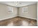 Bedroom featuring hardwood floors, neutral walls, ceiling fan, and dual windows for natural light at 1407 17Th Ne Ave, Hickory, NC 28601