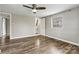 Spacious bedroom with hardwood floors, ceiling fan, natural light, and ensuite bathroom access at 1407 17Th Ne Ave, Hickory, NC 28601
