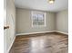 Cozy bedroom featuring hardwood floors, natural light from a window, and neutral wall color at 1407 17Th Ne Ave, Hickory, NC 28601