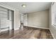 Bedroom with hardwood floors, closet with built-in shelves, and access to the kitchen at 1407 17Th Ne Ave, Hickory, NC 28601