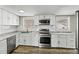 Modern kitchen featuring white cabinets, stainless steel appliances, and subway tile backsplash at 1407 17Th Ne Ave, Hickory, NC 28601
