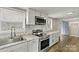Well-lit kitchen featuring stainless steel appliances, white cabinetry and granite countertops at 1407 17Th Ne Ave, Hickory, NC 28601