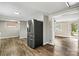 Open area with hardwood floors and stainless steel refrigerator with bonus room views at 1407 17Th Ne Ave, Hickory, NC 28601
