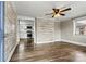 Living room featuring hardwood floors, a ceiling fan, and decorative wall panels at 1407 17Th Ne Ave, Hickory, NC 28601