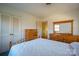 This bright bedroom features ample closet space and a coordinated wood dresser and mirror at 1634 Bonnie Ln, Charlotte, NC 28213