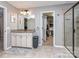 Traditional bathroom features a granite-topped vanity, framed mirror and access to a walk-in closet at 1708 Royal Gorge Ave, Charlotte, NC 28210